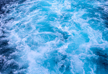 Fototapeta na wymiar Natural surface water background. Sea ship trail with foamy wave.