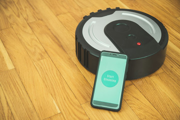 Phone with mobile app to control robotic vacuum cleaner.