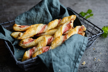 Twisted puff pastry sticks with bacon
