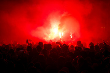 Obraz na płótnie Canvas football fans lit up the lights and smoke bombs. revolution. protest