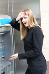 Woman discovering fraud at the ATM