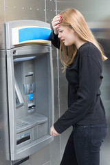 Fototapeta na wymiar Woman discovering fraud at the ATM