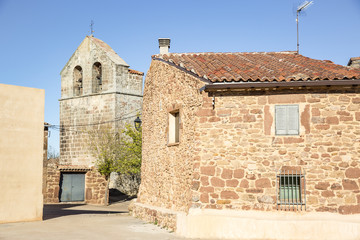 Fototapeta na wymiar the church and a stone made house in Casillas (de Atienza), province of Guadalajara, Castile-La Mancha, Spain