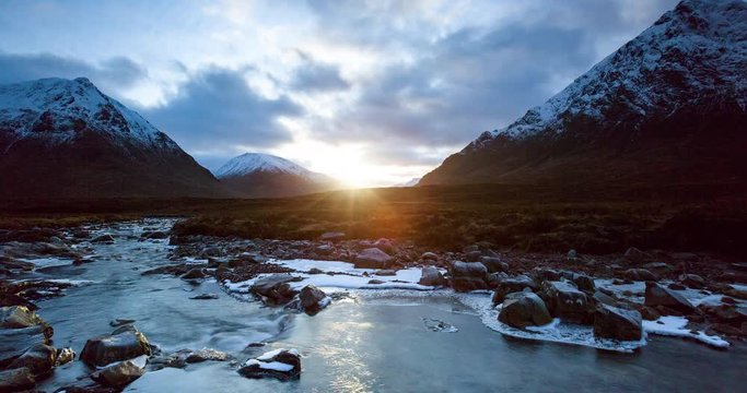 timelapse of sunset on rannoch moor facing buchaille etive mor near glen coe in the remote highlands of scotland during winter with snow on the mountain peaks