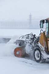 Snowplow truck vehicle removing snow after blizzard and snowstorm in motion/ Urgent city street...