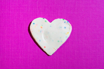Multi-colors valentine heart made with plasticine on pink background