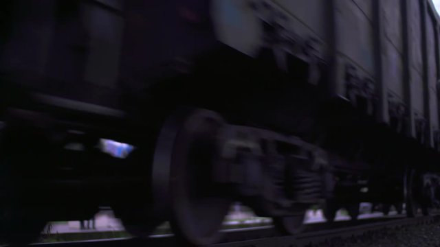 Wheels of the train moving along the rails. Closeup.