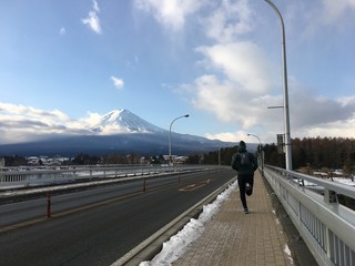 Rear view of man running towards Mt. Fuji
