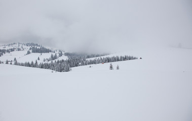 winter in the mountains - small Romanian village in the Carpathians covered with snow