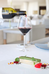 Obraz na płótnie Canvas Elegant dessert served with a glass of wine - molecular gastronomy, haute couture dessert