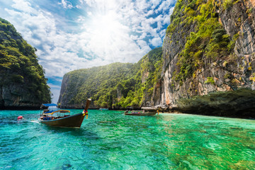 Beautiful landscape with traditional boat on the sea in Phi Phi Lee region of Losama Bay in Thailand - obrazy, fototapety, plakaty