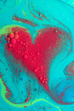 Abstract red heart from acrylic paints and oil