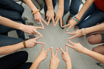 Fototapeta na wymiar People putting hands together as symbol of unity