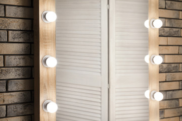 Fototapeta premium Mirror with lamps in modern makeup room