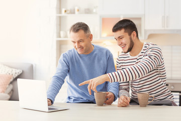 Obraz premium Mature man spending time with his son at home