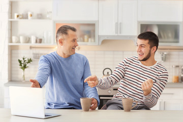 Mature man spending time with his son at home