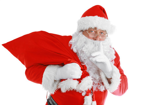 Real Santa Claus carrying big bag full of gifts, isolated on white background.