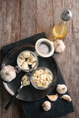Kitchenware and garlic on wooden table