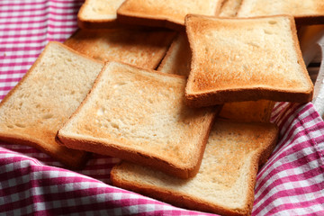 Tasty toasted bread on napkin