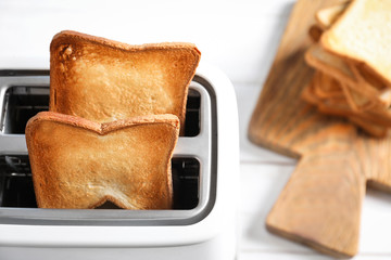 Preparing bread in toaster, closeup