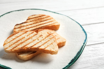Tasty toasted bread on plate