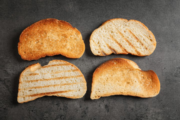 Tasty toasted bread on table