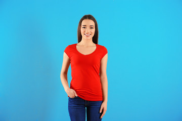 Beautiful young woman in red t-shirt on color background. Mockup for design