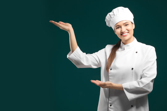 Beautiful female chef on color background