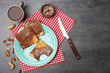 Plate with toasted bread on table