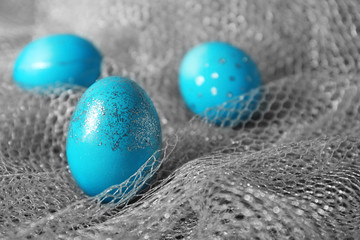 Dyed Easter eggs on grey fabric