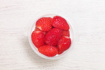 Delicious dessert panna cotta with strawberrieson wooden background