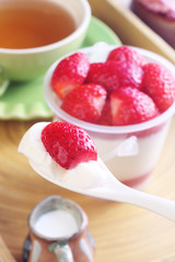 Delicious dessert panna cotta with strawberrieson wooden background