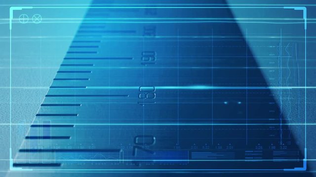 A close up pan along a section of a steel ruler with indented measurements overlaid with a technical data analysis interface
