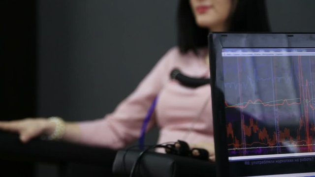 Lie-detector test, a woman answers the questions of the expert