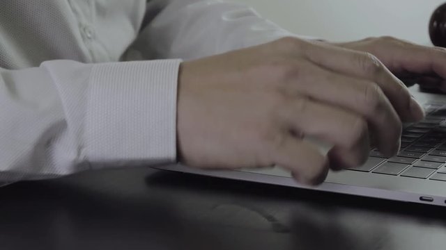 Close up Hand Lawyer working with laptop computer in office in slow motion