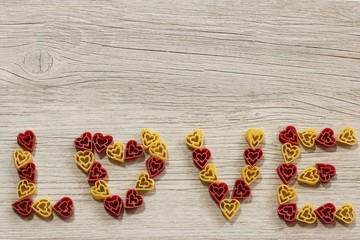 Text Love formed out of heart shaped pasta with copy space