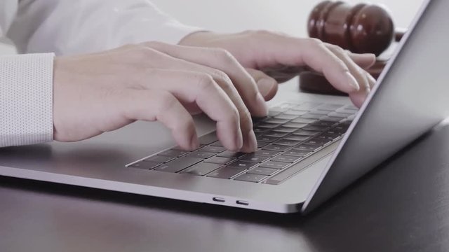 Close up Hand Lawyer working with laptop computer in office in slow motion
