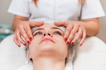 Obraz na płótnie Canvas Beautiful woman having a facial massage beauty treatment