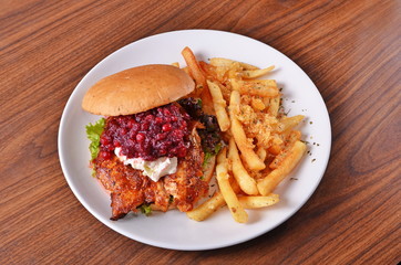 Delicious chicken burger with cranberry, salad and ingredients
