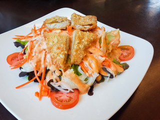 Fried Fish, Salad and Vegetables on Plate, Put on Wood in Restaurant