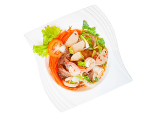 Top view,Thai pork sausage salad.shrimp, carrots, red peppers, onions, squid, in the plate isolated white background.