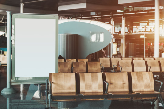 Informational empty banner template partly covered by empty seat rows of Airport terminal waiting hall; clean white mockup of advertising billboard in shopping mall or railway station depot