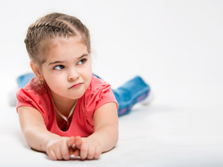 Portrait of a beautiful little girl on a white background. Children's Envy.