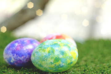 Easter egg laying in the grass bright green.Meaning  celebrate Easter seasonal. Festival of the beginning And rebirth
