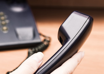 Businessman dialed voip phone in the office. IP Phone connecting to other VOIP device..