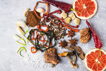 Spices on the stone black background. Condiments on a dark table. Seasoning for cooking.