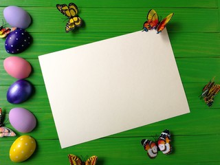 multicolored eggs on wooden green background 