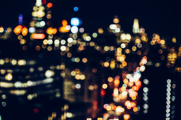 Night New York City Midtown skysrapers in bokeh blur - obrazy, fototapety, plakaty