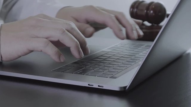 Close up Hand Lawyer working with laptop computer in office in slow motion