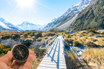 Compass with natural blur background. Travel concept.